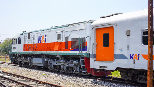 CC 201 77 16 diesel locomotive train of PT KAI stopped at Gundih railway station in Grobogan Central Java Indonesia. Classic public transport engine on railroad track under bright sunny sky.