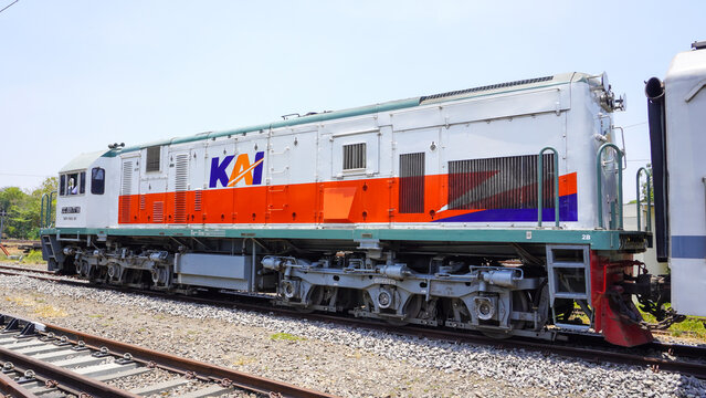 CC 201 77 16 diesel locomotive train of PT KAI stopped at Gundih railway station in Grobogan Central Java Indonesia. Classic public transport engine on railroad track under bright sunny sky.