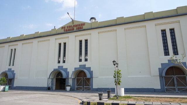 Front exterior view of historic De Tjolomadoe sugar mill heritage site built in 1861 with Dutch colonial architecture, arch doors, and yellow facade wall in Karanganyar, Central Java, Indonesia.