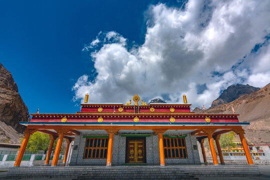 View of Key Monastery in Spiti Valley with traditional Tibetan architecture, orange pillars, and a dramatic mountain backdrop in Kaza, Himachal Pradesh, India.