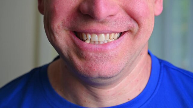 Close-up portrait of a man transitioning from a neutral expression to a warm, toothy smile