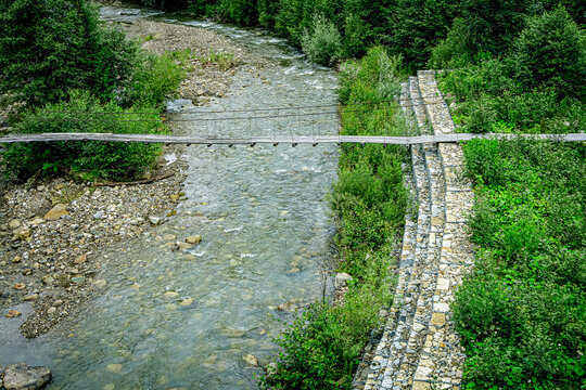 Suspension bridge over mountain river