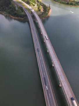 Aerial view of a highway bridge crossing a scenic lake