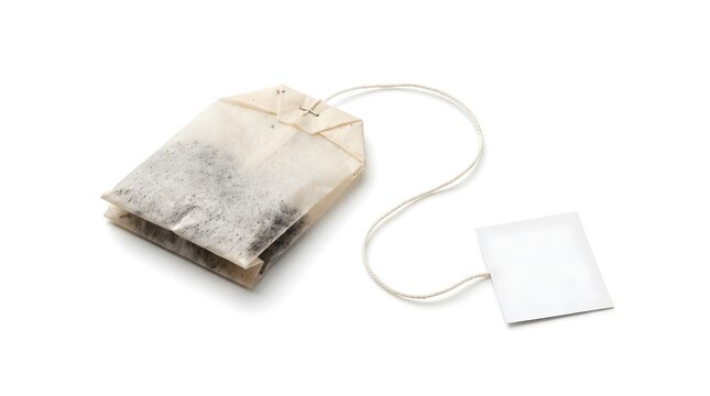 Used steeped tea bag with tea leaves inside and white paper tag on string isolated on white background