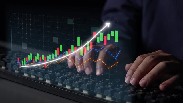 A businessman focuses on stock market analysis using charts and graphs displayed on a keyboard. The image captures digital finance concepts in a modern setting. Copula