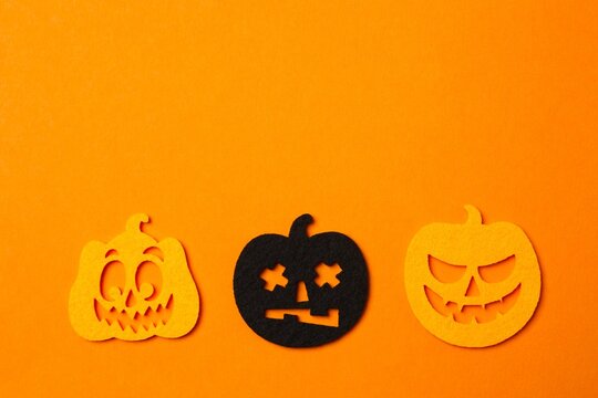 Halloween festive pattern with decorative pumpkins on orange background