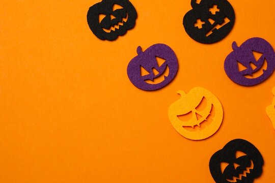 Halloween festive pattern with decorative pumpkins on orange background, copy spae