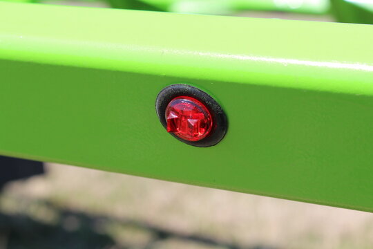 Red marker light set in a bright green steel tube frame