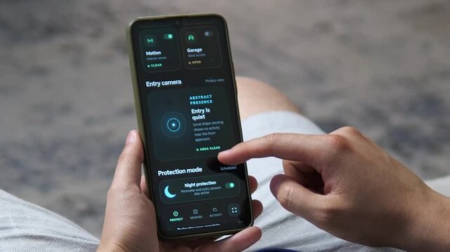 Person reviews smart home security events and night protection on a smartphone, reflecting growing demand for remote access, real-time monitoring and connected home safety.