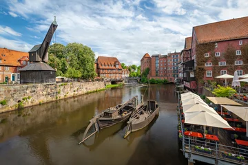 Luneburg, Germany - View of old hanseatic harbor with Ilmenau river, boats and historic crane © bbsferrari