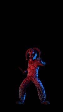 Creepy seamless vertical video of an horror clown with a knife and colorful lights. Halloween background of a terror character stabbing isolated with copy space