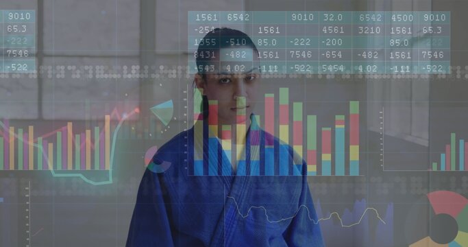 Standing adult male in blue gi facing studio with tall windows, faint financial charts overlaying