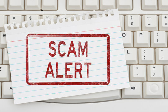Scam Alert warning sign on a keyboard