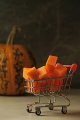 Miniature shopping cart filled with orange pumpkin cubes © Nazar 
