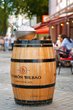 Minsk, Belarus. 5 Aug, 18. Champagne bottles chilling in ice bucket on Ramon Bilbao wooden wine barrel, outside urban terrace cafe. Wooden wine barrel with an ice bucket full of champagne bottles