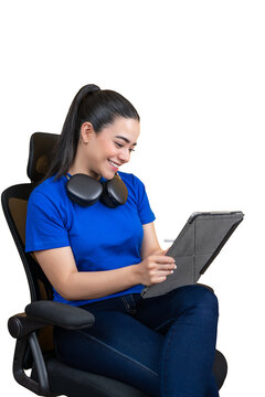 Smiling woman wearing headphones and using a tablet against transparent background