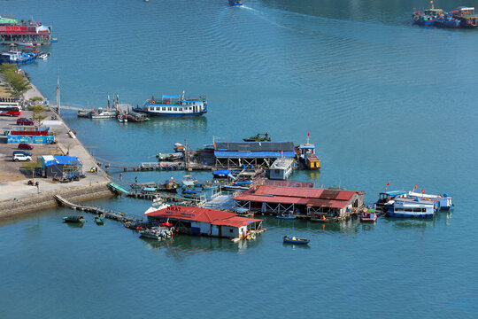 High angle view of traditional floating houses and tourist boats at Ben Beo harbor on Cat Ba Island, Vietnam.