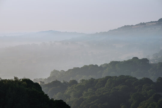 Beautiful landscape image over Stanton Moor in Summer Heather sunrise
