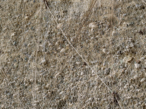 Steel rockfall protection mesh on a rock face