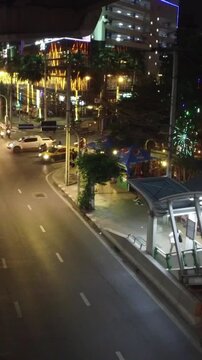 Night view of Bangkok street with taxis from elevated BTS walkway, Thailand