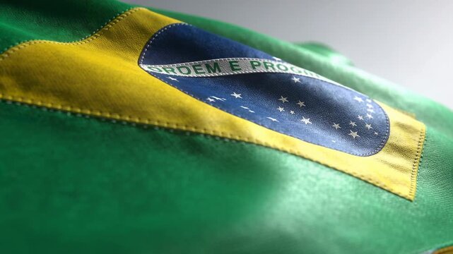 Rippling Brazilian flag driven by soft airflow in studio revealing emblem and Ordem e Progresso