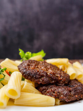 Meal with two tasty burgers, pasta and fresh salad and no sauce. Diet dinner for people with high blood sugar. Healthy food.