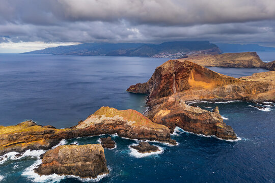 Rugged volcanic coast of Ponta de Sao Lourenco with layered cliffs and rocky formations in Atlantic Ocean, Madeira, Portugal. Drone footage