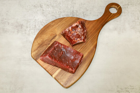 Traditional Mexican Dulce de Calabaza y Camote (candied pumpkin and sweet potato) on a wooden board.