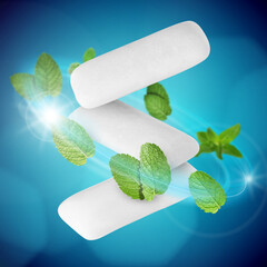 Menthol chewing gum pieces and mint leaves in air against blue background © New Africa