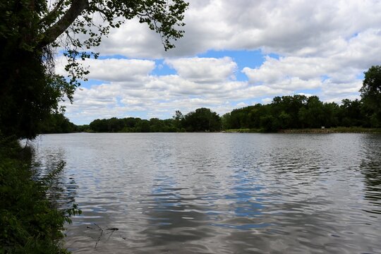The flowing peaceful river in the woods.