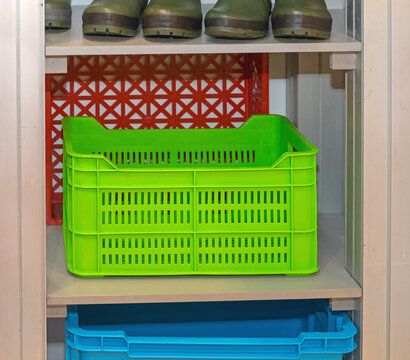 Green Plastic Crate at Shelf in Storage Room Farm
