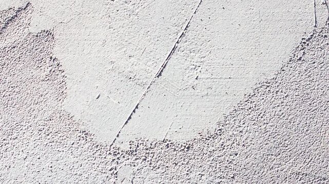 A plastered wall. Gray, rough, grunge-style plaster the surface of a wall inside a room a background, animation