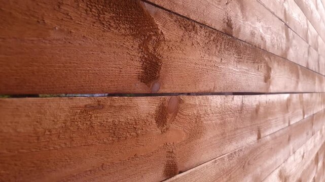 A fence made of wooden planks. Authentic wooden planks, a barrier.