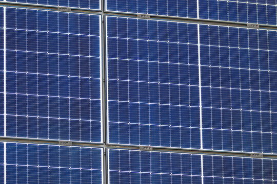 Closeup photovoltaic solar panels creating renewable energy pattern.