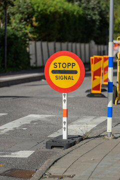Temporary stop signal sign at Swedish urban roadworks.