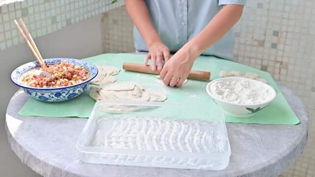 Housewife making dumplings by hand at home