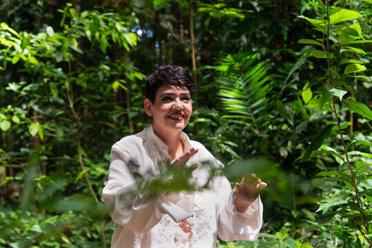 Smiling woman with green foliage