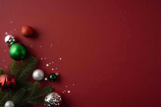 Merry Christmas ornament flatlay with pine branches and festive baubles wishing Happy New Year