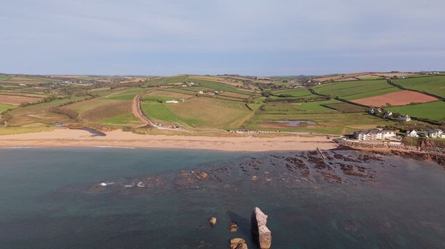 Aerial drone footage of South Milton Sands in South Devon, showcasing the sandy beach, turquoise coastal waters, rugged shoreline and scenic landscape of the English coast