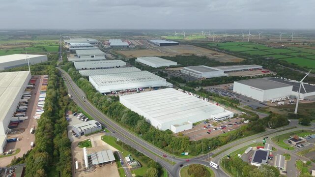 Aerial View of Logistics Park Warehouses and Wind Turbines Near Crick UK