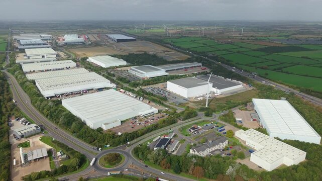 Aerial View of Logistics Park Warehouses and Wind Turbines Near Crick UK