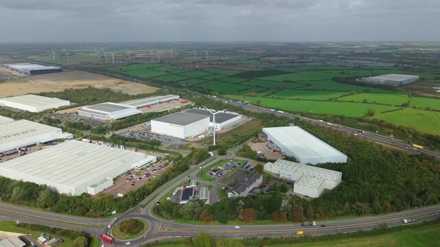 Aerial View of Logistics Park Warehouses and Wind Turbines Near Crick UK