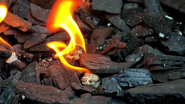 Close-Up of Bright Orange Flame Over Burning Charcoal and Embers, Intense Heat and Firelight