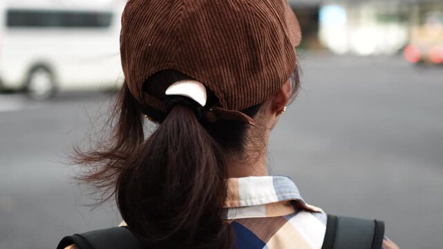 Woman Walking Through City Street at Dusk Rear View Slow Motion