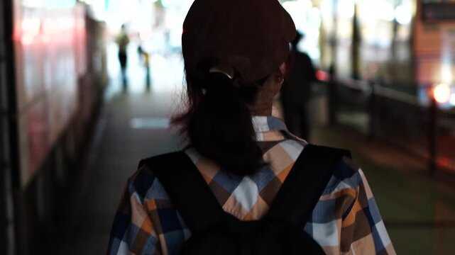 Woman Walking Through City Street at Dusk Rear View Slow Motion