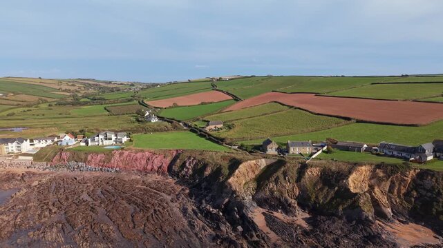 Aerial drone footage of South Milton Sands in South Devon, showcasing the sandy beach, turquoise coastal waters, rugged shoreline and scenic landscape of the English coast
