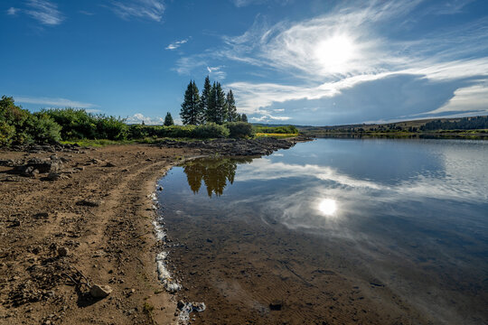 Calm Heart Lake in Flat Tops Wilderness Area in Garfield County, Colorado under dramatic summer cloudscape.