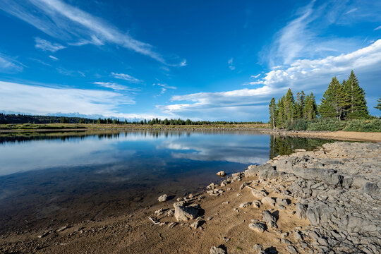 Calm Heart Lake in Flat Tops Wilderness Area in Garfield County, Colorado under dramatic summer cloudscape.