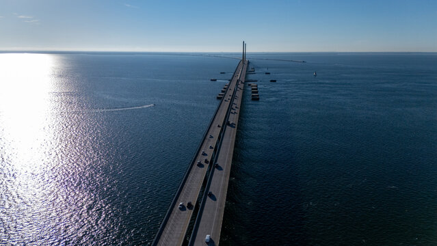 Aerial view of the Sunshine Skyway Bridge spanning across the blue waters of Tampa Bay with cars driving on the road in St. Petersburg, Florida, United States.
