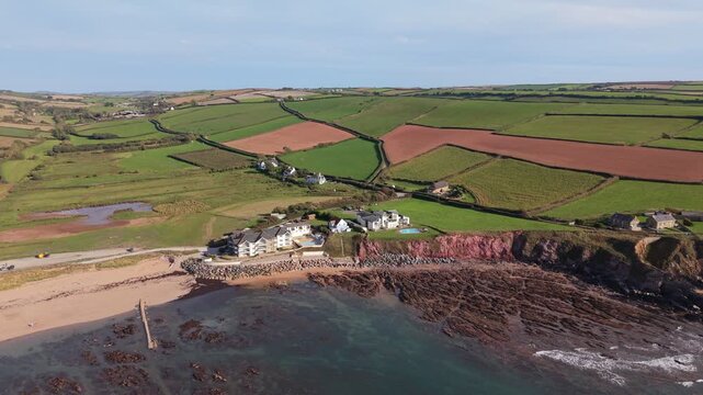 Aerial drone footage of South Milton Sands in South Devon, showcasing the sandy beach, turquoise coastal waters, rugged shoreline and scenic landscape of the English coast